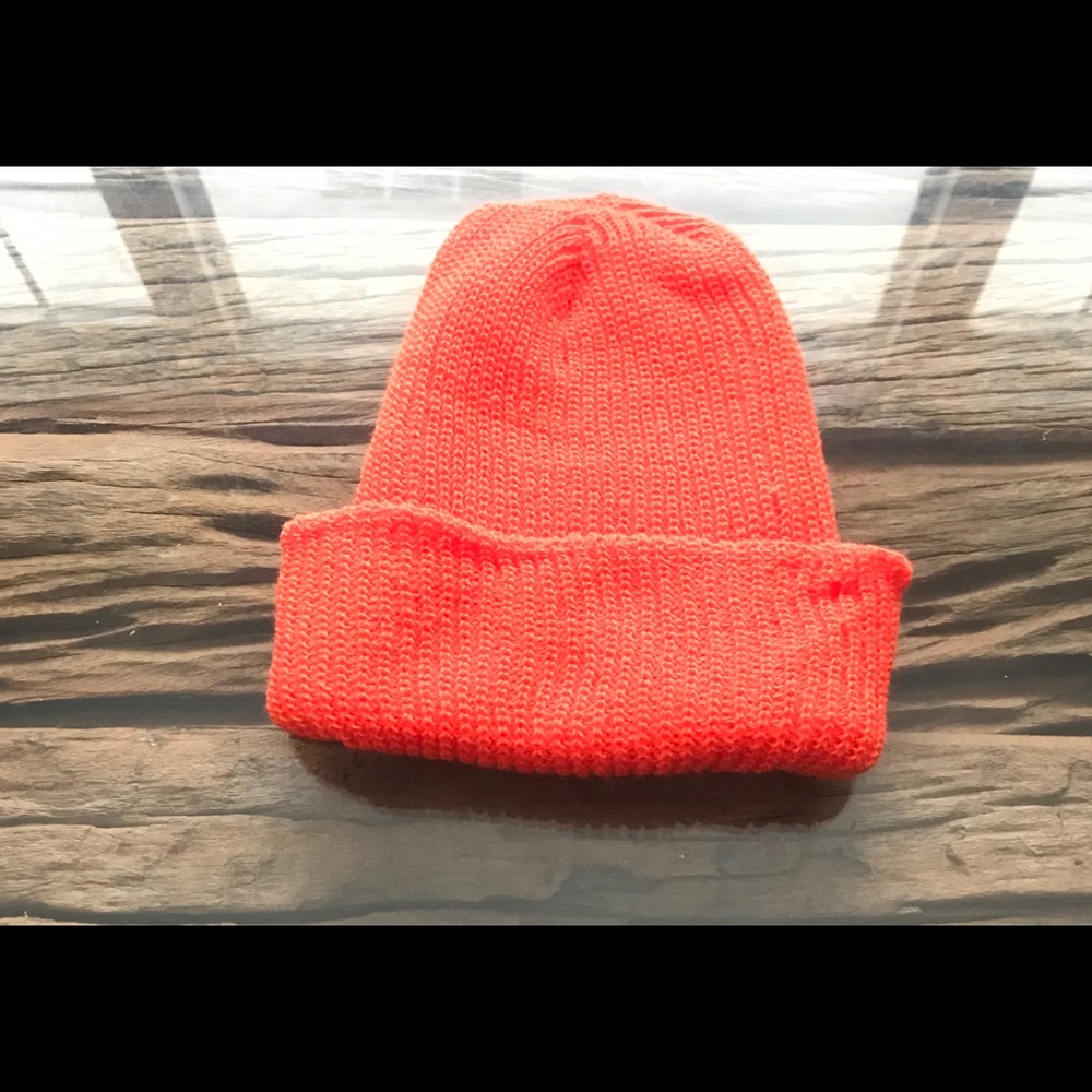 Winter hat. Neon orange color. Knitted hat.
